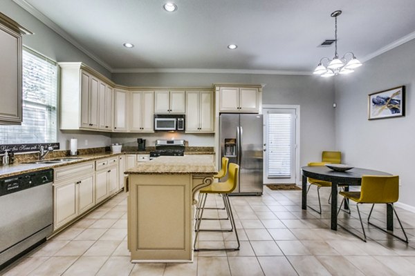 Modern kitchen with stainless steel appliances at Addicks Stone Village Apartments, a luxury community offering upscale living spaces