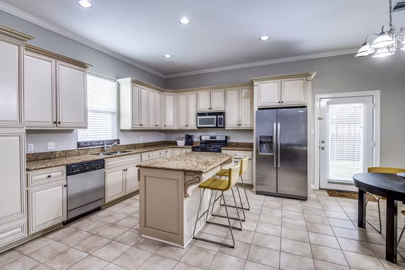 Modern kitchen with stainless steel appliances in Addicks Stone Village Apartments