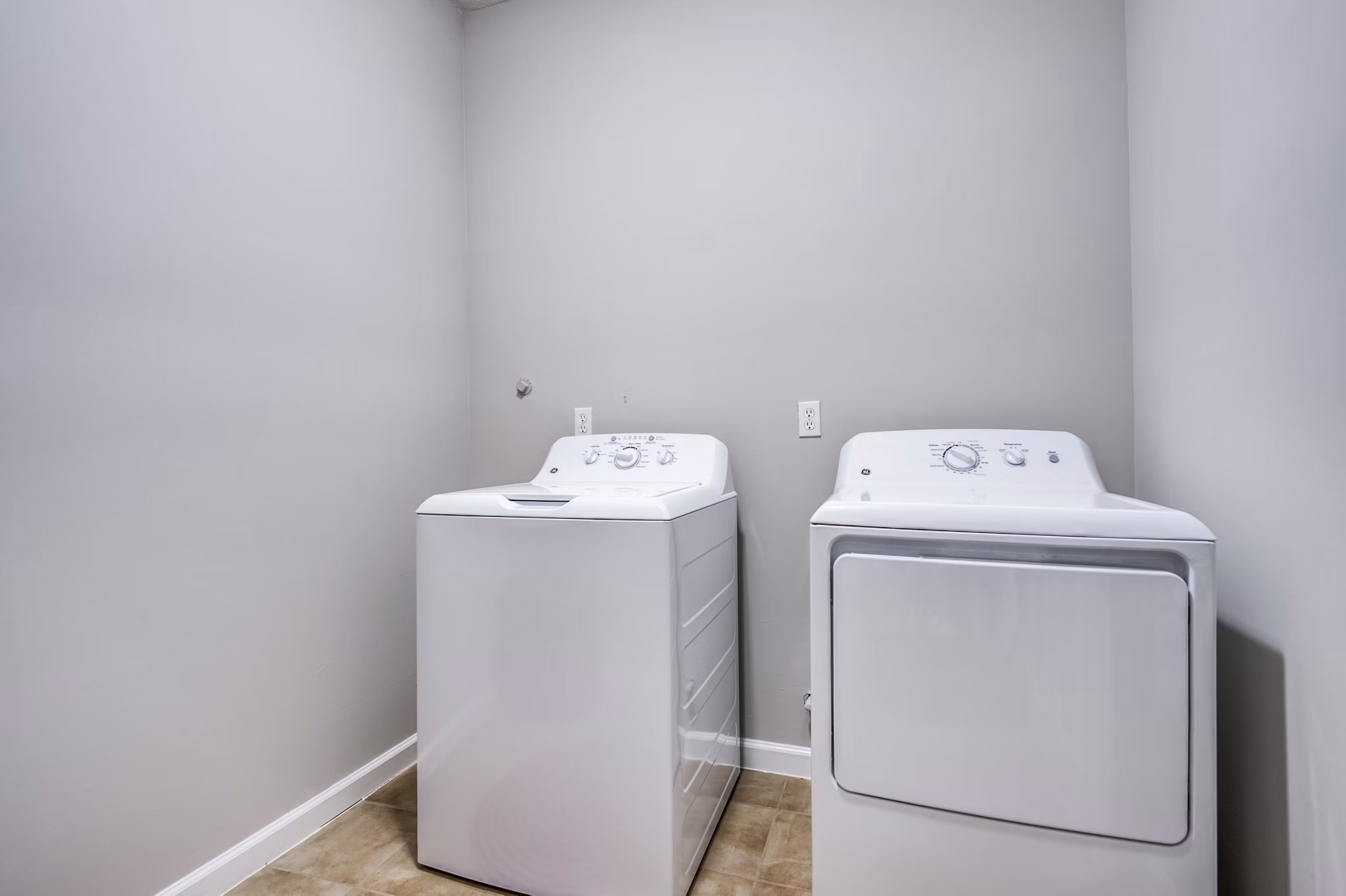 Laundry room with energy-efficient washers and dryers at Addicks Stone Village Apartments