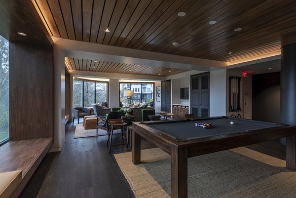 Game room with billiards and lounge seating at Bayou on the Bend Apartments