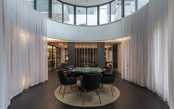 Poker table with chairs in a modern lounge at luxury apartments