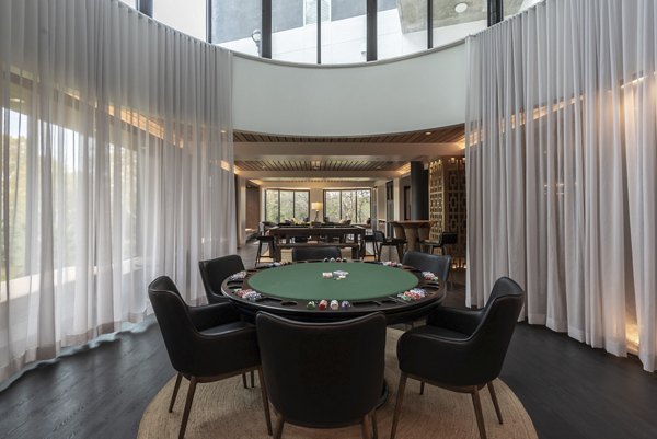 Game room with pool table and seating at Bayou on the Bend Apartments