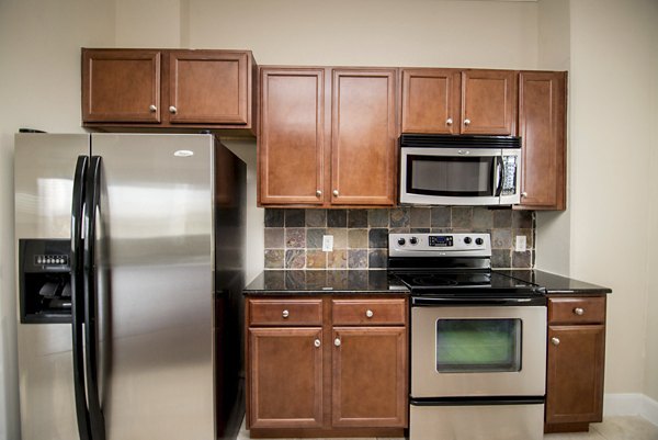 Modern kitchen with stainless steel appliances at Bayou on the Bend Apartments in Houston