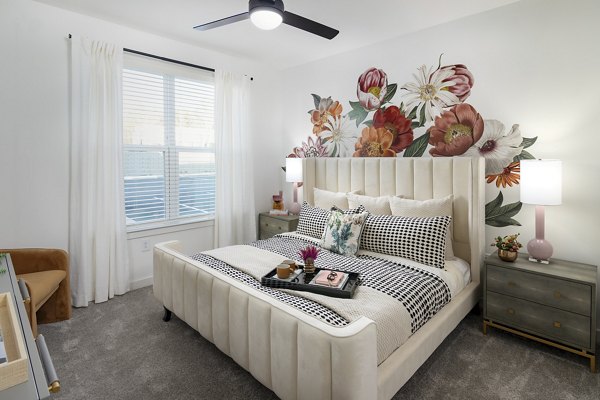 Bedroom with modern furnishings and neutral tones at Marlowe South Fulton Apartments, luxury residence by Greystar