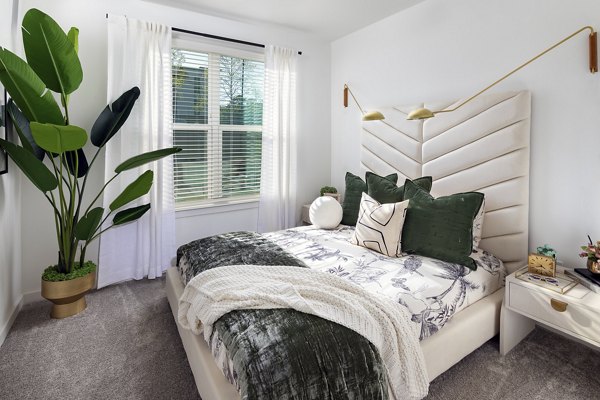 Cozy bedroom with modern decor at Marlowe South Fulton Apartments, offering luxury living spaces near Atlanta