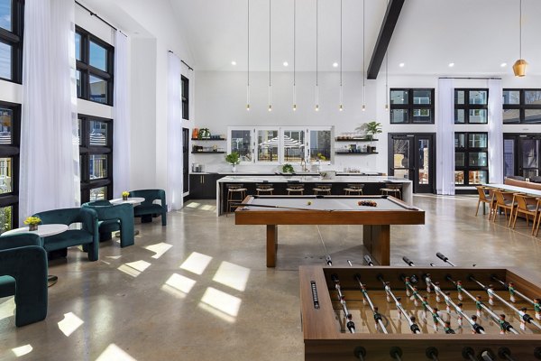 Clubhouse game room with modern decor at Marlowe South Fulton Apartments