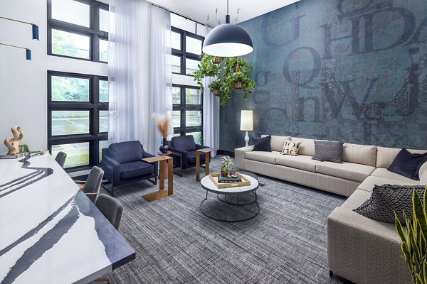 Modern clubhouse with cozy seating and fireplace at Marlowe South Fulton Apartments, ideal for gatherings and relaxation
