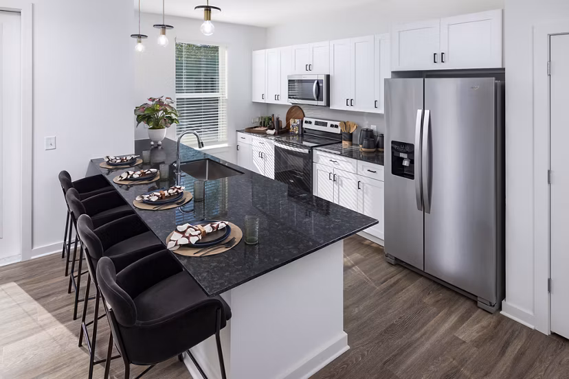 Modern kitchen with stainless steel appliances and granite countertops at Marlowe South Fulton Apartments
