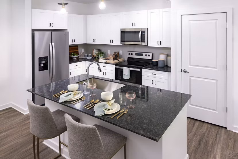 Luxurious kitchen with stainless steel appliances and granite countertops in Marlowe South Fulton Apartments