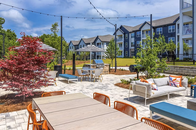 Grill area with modern patio seating at Marlowe South Fulton Apartments