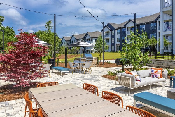 Grill area with modern patio seating at Marlowe South Fulton Apartments
