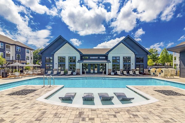 Stunning outdoor pool at Marlowe South Fulton Apartments with lounge seating and landscaping