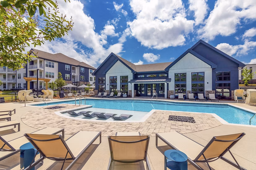 Inviting resort-style pool surrounded by palm trees at Marlowe South Fulton Apartments