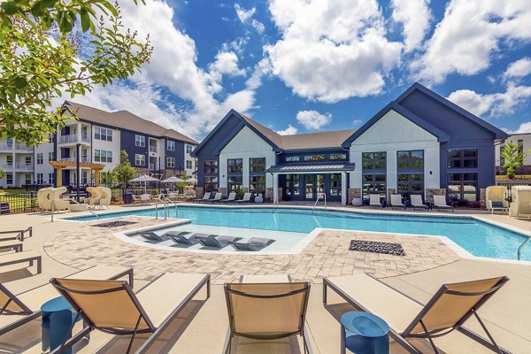 Inviting resort-style pool surrounded by palm trees at Marlowe South Fulton Apartments