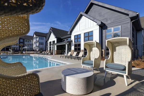 Luxurious poolside relaxation area at Marlowe South Fulton Apartments, featuring modern lounge chairs and vibrant landscaping