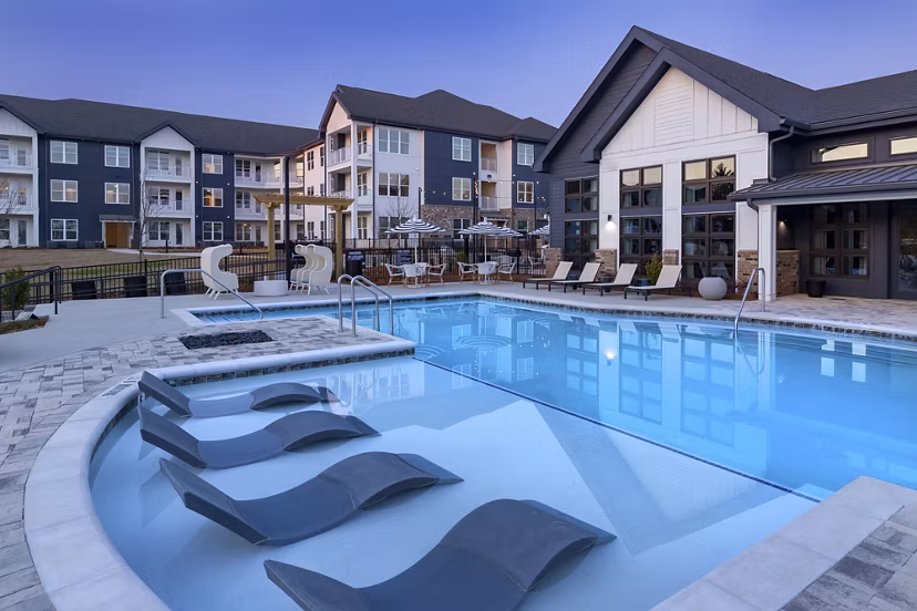 Outdoor pool area with lounge chairs at Marlowe South Fulton Apartments, featuring luxury relaxation amenities
