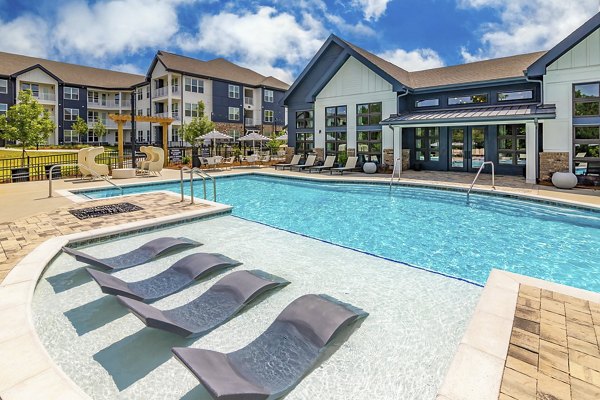 Luxury outdoor pool with lounge area at Marlowe South Fulton Apartments in Atlanta, ideal for relaxation and leisure activities