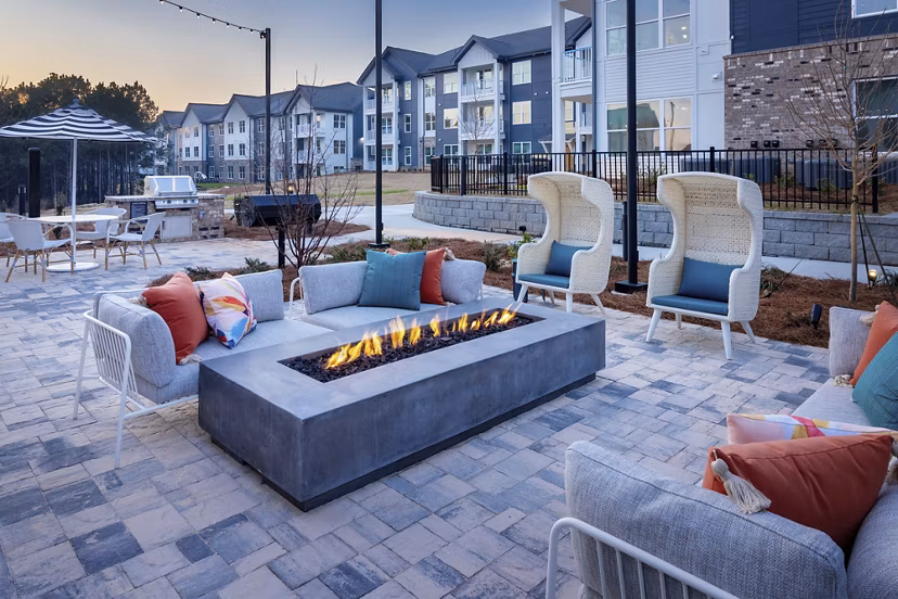 Fire pit lounge area at Marlowe South Fulton Apartments, offering cozy outdoor relaxation space with seating and ambient lighting