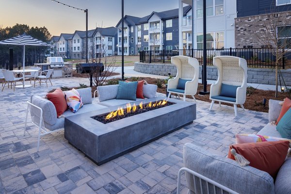 Fire pit lounge area at Marlowe South Fulton Apartments, offering cozy outdoor relaxation space with seating and ambient lighting