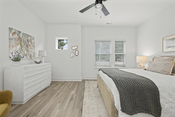 Comfortable bedroom with modern furnishings at Cascadia at Highland Creek Apartments