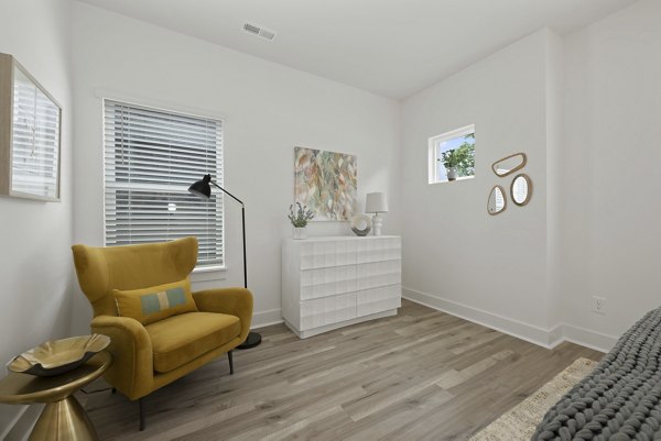 Bedroom with modern design and stylish furniture in Cascadia at Highland Creek Apartments