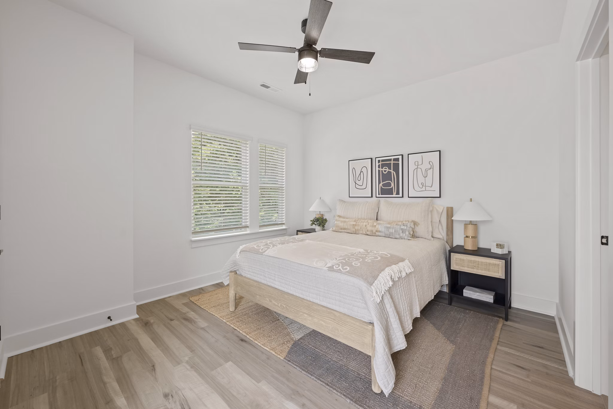 Elegant bedroom with large windows and designer furnishings at Cascadia at Highland Creek Apartments