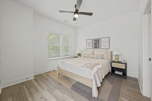 Elegant bedroom with large windows and designer furnishings at Cascadia at Highland Creek Apartments