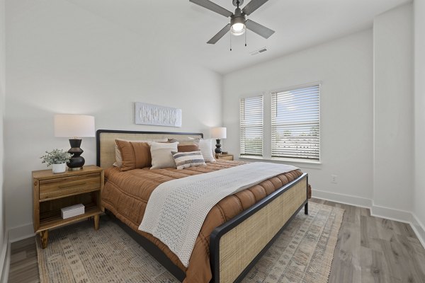 Cozy bedroom with modern furnishings at Cascadia at Highland Creek Apartments