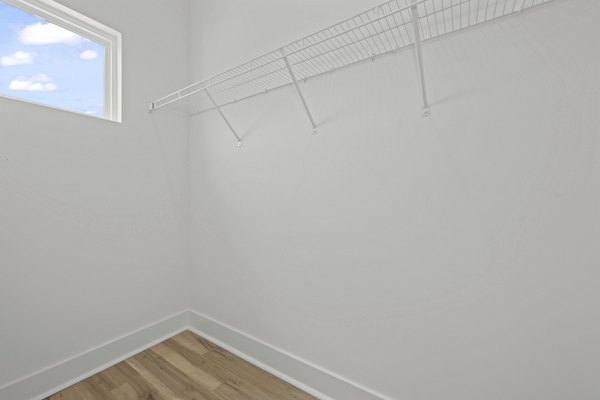 Walk-in closet with ample storage space at Cascadia at Highland Creek Apartments