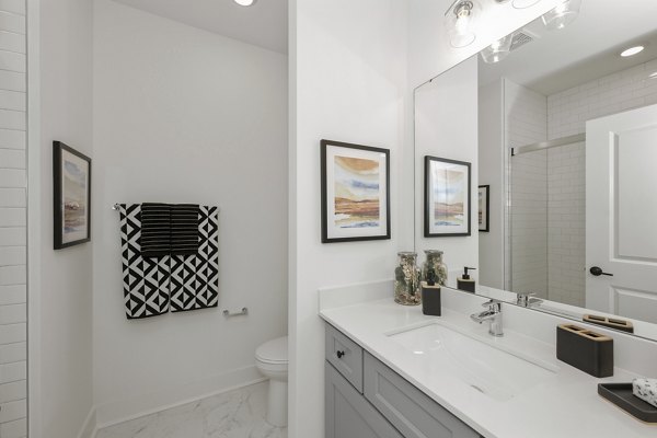 Modern bathroom featuring sleek fixtures and ample storage at Cascadia at Highland Creek Apartments