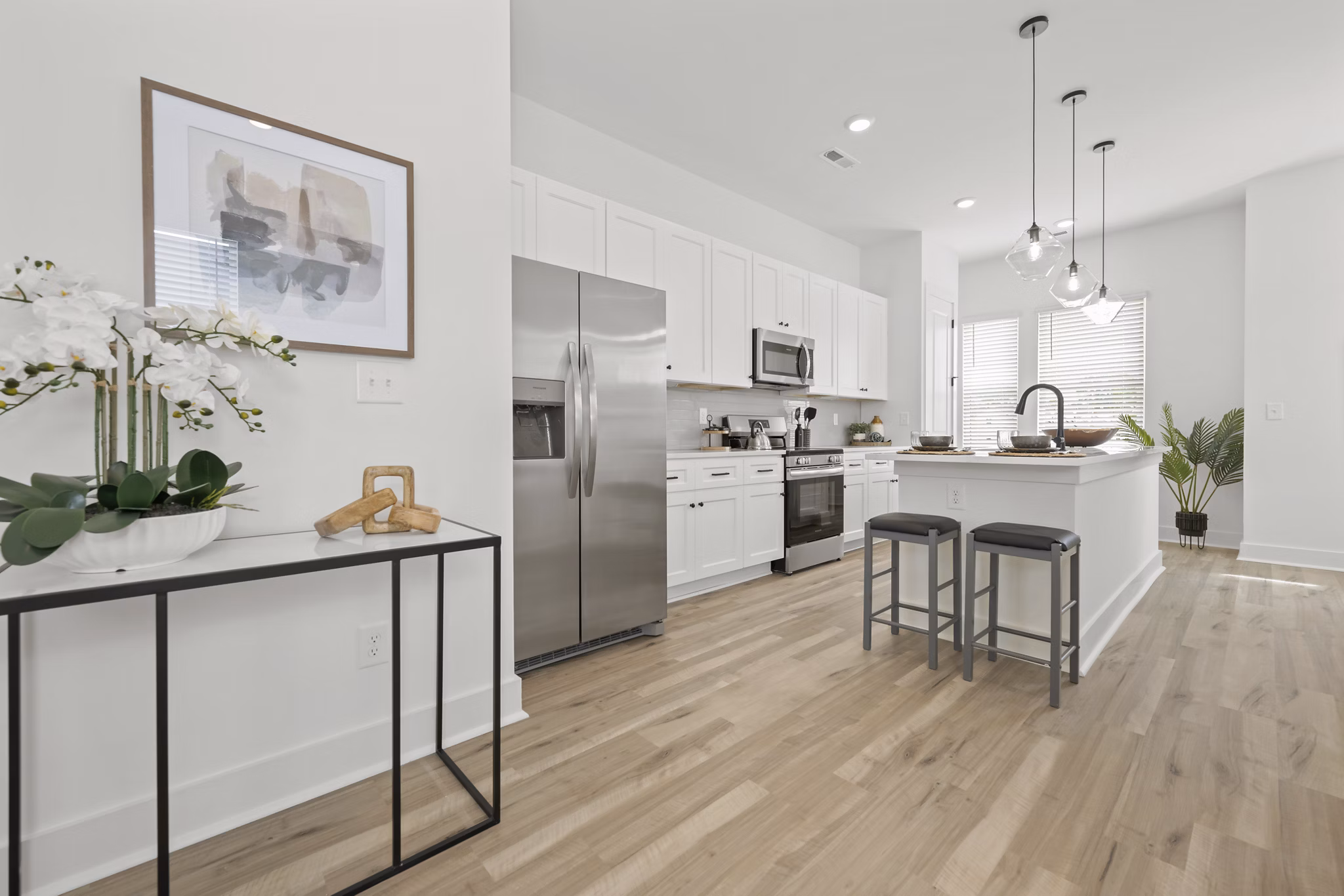Modern kitchen with granite countertops and stainless steel appliances in Cascadia at Highland Creek Apartments