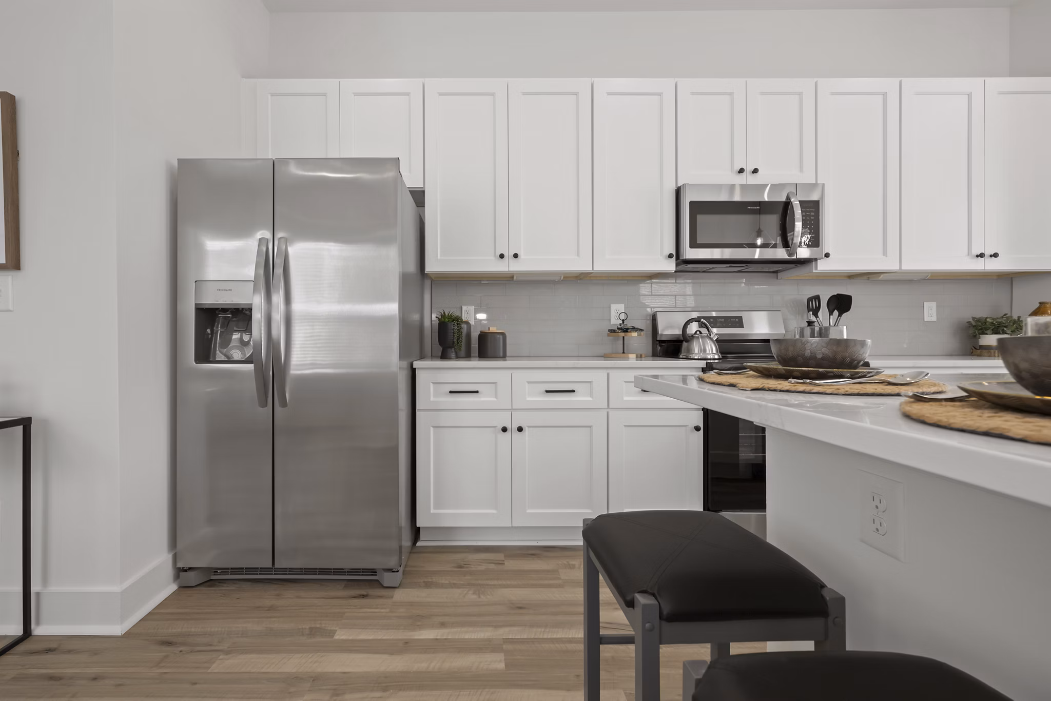 Modern kitchen featuring stainless steel appliances and granite countertops at Cascadia at Highland Creek Apartments