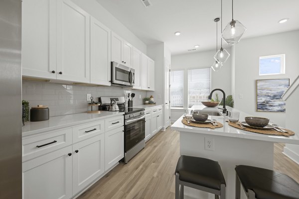 Cascadia at Highland Creek Apartments: Modern kitchen featuring sleek countertops and stainless steel appliances