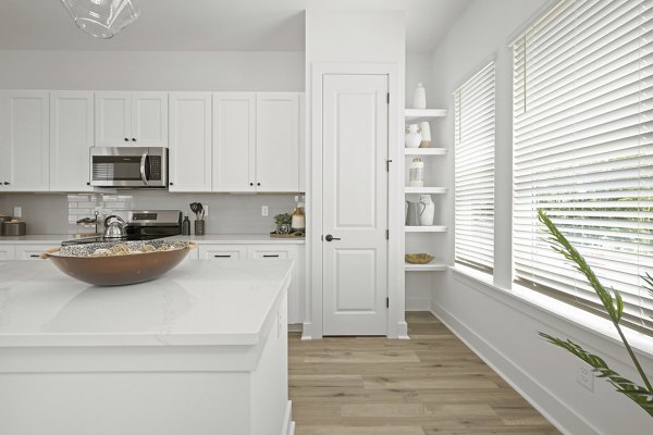 Modern kitchen with stainless steel appliances at Cascadia at Highland Creek Apartments