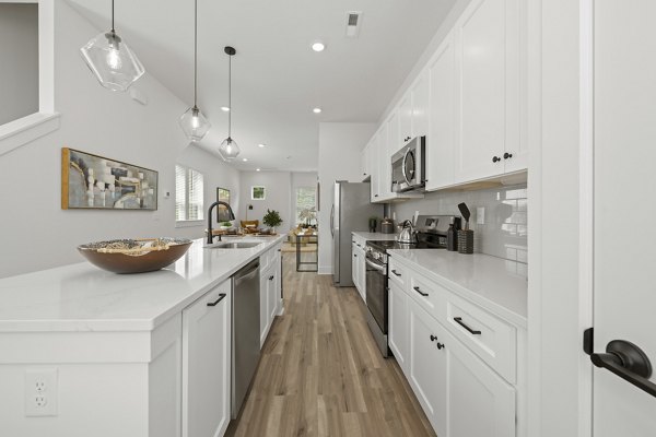 Modern kitchen with stainless steel appliances at Cascadia at Highland Creek Apartments