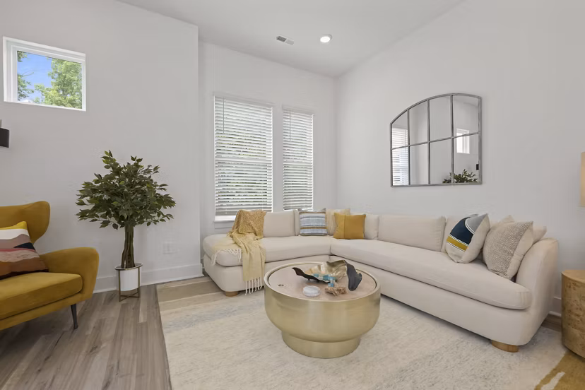 Spacious living room with modern dÃ©cor at Cascadia at Highland Creek Apartments