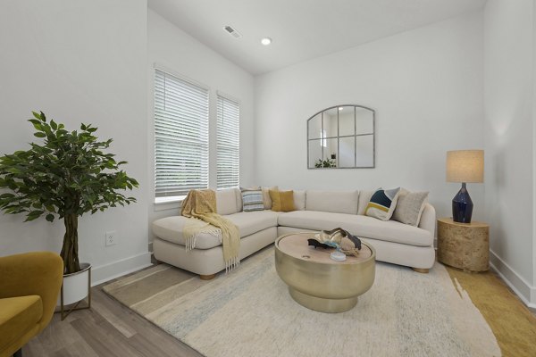 Spacious living room with stylish furnishings at Cascadia at Highland Creek Apartments
