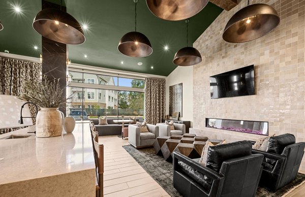 Modern clubhouse with lounge seating and billiards at Elan Prosperity Village Apartments