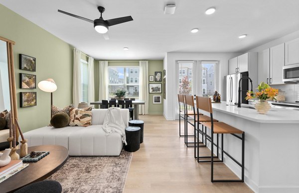 Modern kitchen with granite countertops and stainless steel appliances in Elan Prosperity Village Apartments