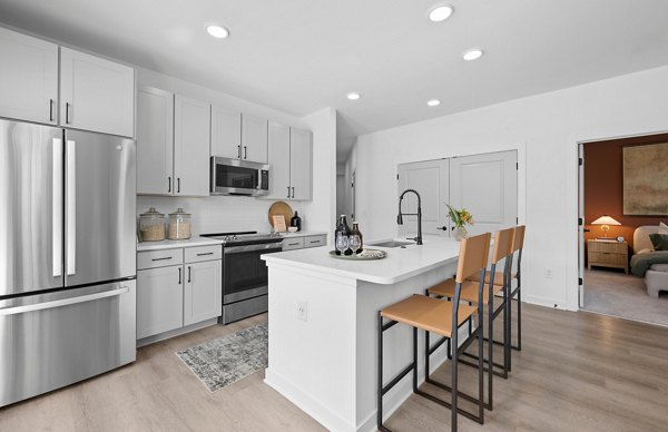 Modern kitchen with sleek cabinetry and stainless steel appliances at Elan Prosperity Village Apartments Perfect blend of style and functionality