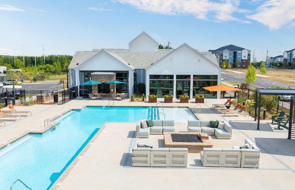 Luxurious pool with stylish loungers at Elan Prosperity Village Apartments, ideal for relaxing and leisure activities