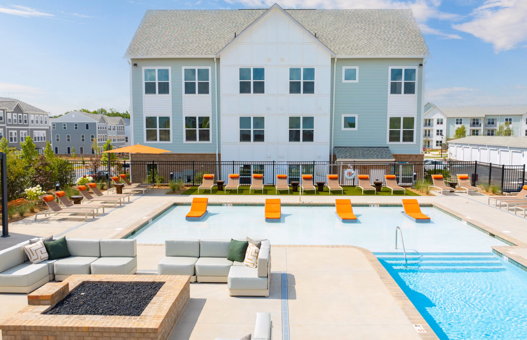 Inviting pool area surrounded by lush landscaping at Elan Prosperity Village Apartments, perfect for relaxation and leisure activities