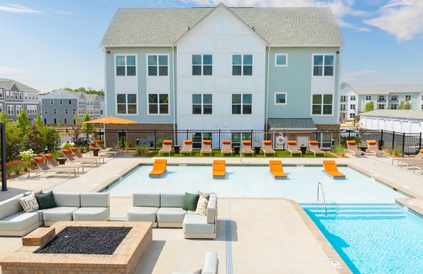 Inviting pool area surrounded by lush landscaping at Elan Prosperity Village Apartments, perfect for relaxation and leisure activities