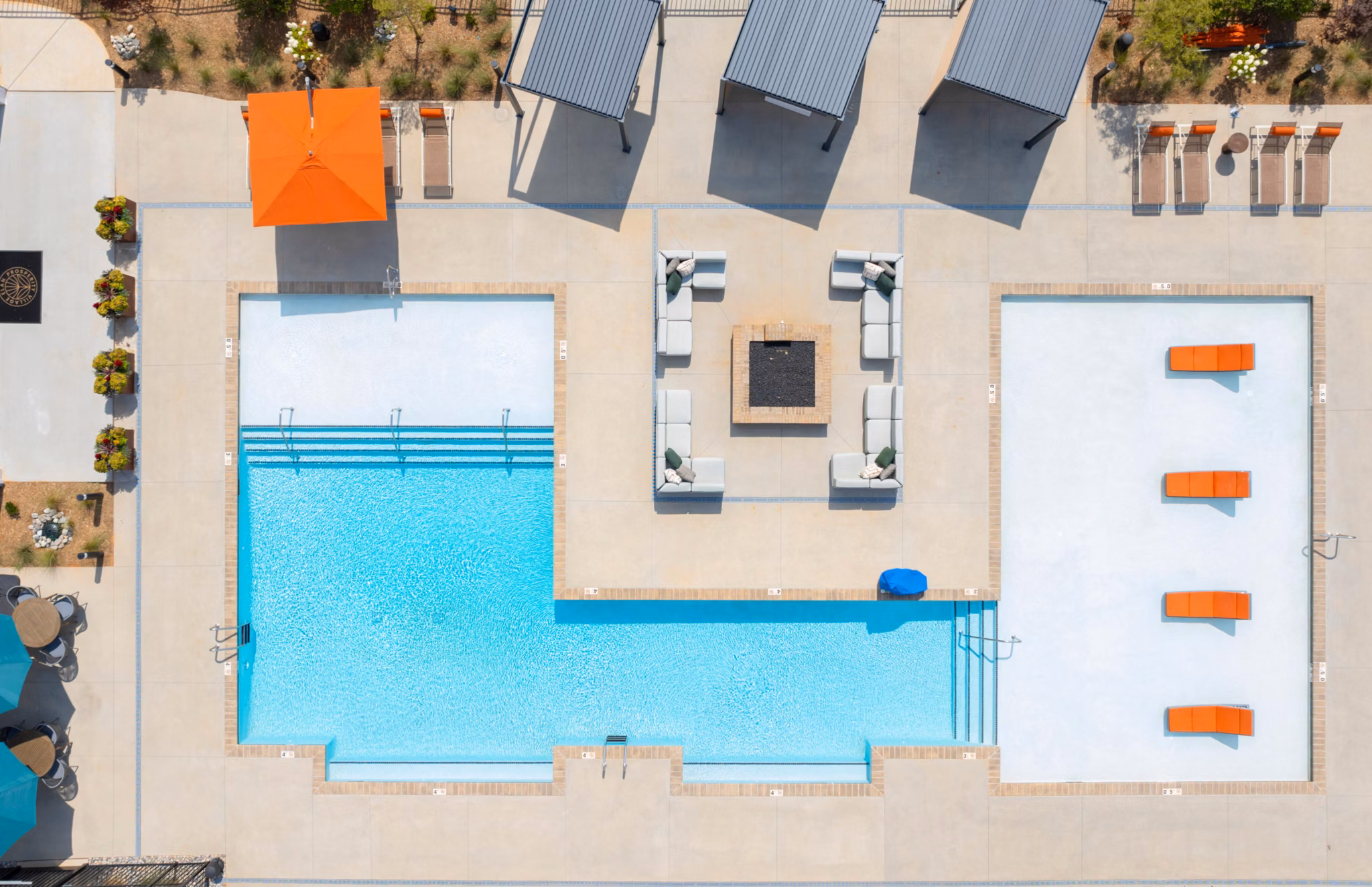 Resort-style outdoor pool with lounge area at Elan Prosperity Village Apartments, offering luxury living amenities