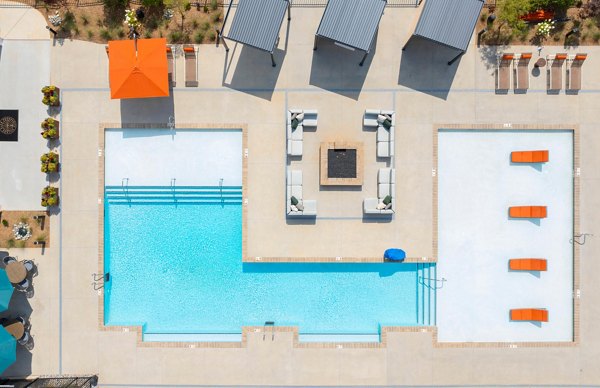 Resort-style outdoor pool with lounge area at Elan Prosperity Village Apartments, offering luxury living amenities