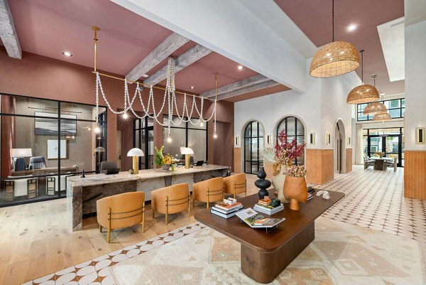 Modern clubhouse featuring entertainment lounge at Asher Apartments, a Greystar luxury community