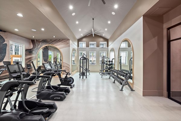 State-of-the-art fitness center featuring modern equipment at Asher Apartments