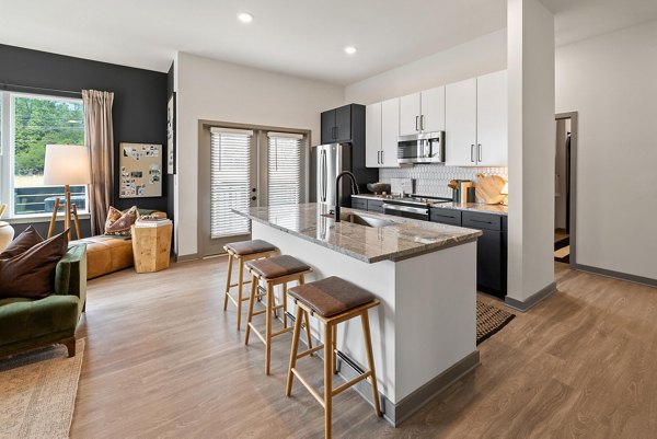 Modern kitchen with quartz countertops and stainless steel appliances at Asher Apartments