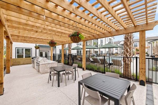 Grill area with modern patio furniture at Asher Apartments, a luxury community by Greystar