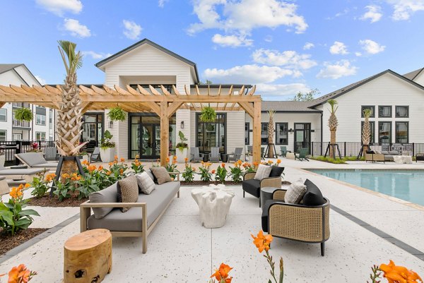 Chic outdoor patio with stylish seating at Asher Apartments, offering serene social space for residents